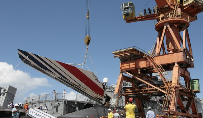Workers unloading debris, belonging to crashed Air France flight AF447, from the Brazilian Navy&#x27;s Constitution Frigate in the port of Recife, northeast of Brazil, Sunday, June 14, 2009. A French court is ruling Monday, April 17, 2023, on whether Airbus and Air France are guilty of manslaughter over the 2009 crash of Flight 447 en route from Rio to Paris, which killed 228 people and led to lasting changes in aircraft safety measures. (AP Photo/Eraldo Peres) **FILE**