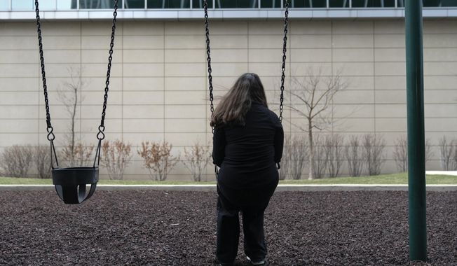 Amelia, 16, sits for a portrait in a park near her home in Illinois on Friday, March 24, 2023. “We are so strong and we go through so, so much,&quot; says the teenage girl who loves to sing and wants to be a surgeon. Amelia has also faced bullying, toxic friendships, and menacing threats from a boy at school who said she “deserved to be raped.&quot; (AP Photo Erin Hooley)