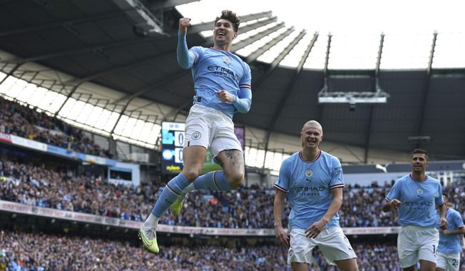 Manchester City&#x27;s John Stones, center, celebrates after scoring his side&#x27;s opening goal during the English Premier League soccer match between Manchester City and Leicester City at Etihad Stadium in Manchester, England, Saturday, April 15, 2023. (Nick Potts/PA via AP)