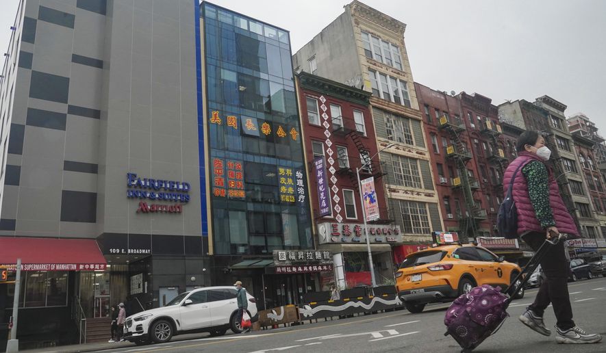 A six-story glass facade building (second from left) is believed to be the site of a foreign police outpost for China in New York&#x27;s Chinatown on Monday April 17, 2023. Justice Department officials say two men have been arrested on charges that they helped establish a secret police outpost in New York City on behalf of the Chinese government. (AP Photo/Bebeto Matthews) **FILE**
