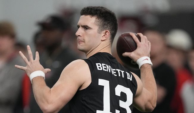 Former Georgia quarterback Stetson Bennett throws during drills at Georgia football Pro Day, Wednesday, March 15, 2023, in Athens, Ga. In the first nine drafts after former sixth-round pick Tom Brady won his first Super Bowl following the 2002 season, there were an average of seven QBs taken in the final three rounds of the draft. (AP Photo/John Bazemore, File)