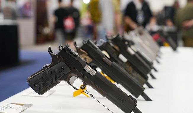 An array of pistols are shown in the Dan Wesson display as guests browse firearms at the National Rifle Association&#x27;s Annual Meetings &amp; Exhibits in Indianapolis, April 16, 2023. The roster of Republican presidential hopefuls who flocked to the National Rifle Association&#x27;s annual convention reflects the political potency of gun rights, despite the group&#x27;s eroding revenues and an opposition movement that&#x27;s growing increasingly vocal as the drumbeat of mass shootings marches on.(AP Photo/Michael Conroy, File)