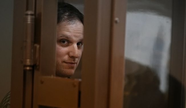 Wall Street Journal reporter Evan Gershkovich stands in a glass cage in a courtroom at the Moscow City Court, in Moscow, Russia, on Tuesday, April 18, 2023. (AP Photo/Alexander Zemlianichenko)