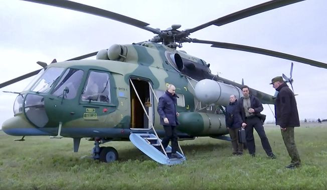 In this photo taken from video released by Russian TV Pool on Tuesday, April 18, 2023, Russian President Vladimir Putin arrives at an undisclosed location. The Kremlin says Putin has visited headquarters of the Russian troops fighting in Ukraine. (Pool Photo via AP)