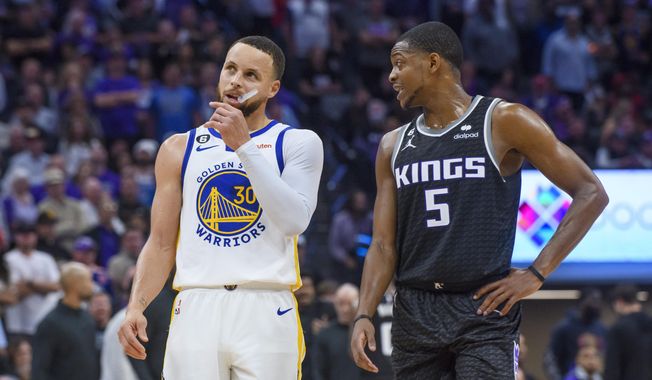 Golden State Warriors guard Stephen Curry (30) and Sacramento Kings guard De&#x27;Aaron Fox (5) talk during a timeout during the second half of Game 2 in the first round of the NBA basketball playoffs in Sacramento, Calif., Monday, April 17, 2023. The Kings won 114-106. (AP Photo/Randall Benton) **FILE**