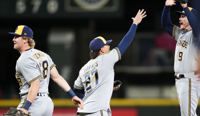 Milwaukee Brewers&#x27; Joey Wiemer, left, celebrates the team&#x27;s 6-5 victory over the Seattle Mariners with Willy Adames, center, and Brian Anderson, right, after a baseball game Tuesday, April 18, 2023, in Seattle. (AP Photo/Lindsey Wasson)