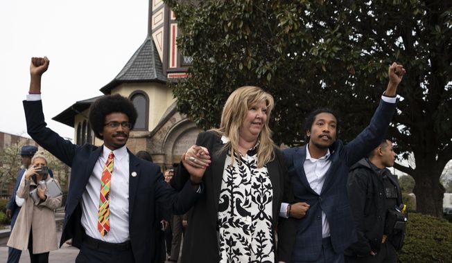 From left, expelled Rep. Justin Pearson, D-Memphis, Rep. Gloria Johnson, D-Knoxville, and expelled Rep. Justin Jones, D-Nashville raise their fists as they walk across Fisk University campus after hearing Vice President Kamala Harris speak, Friday, April 7, 2023, in Nashville, Tenn. Harris came to support the two Democratic lawmakers, who were expelled from the Tennessee State Legislature. (AP Photo/George Walker IV)