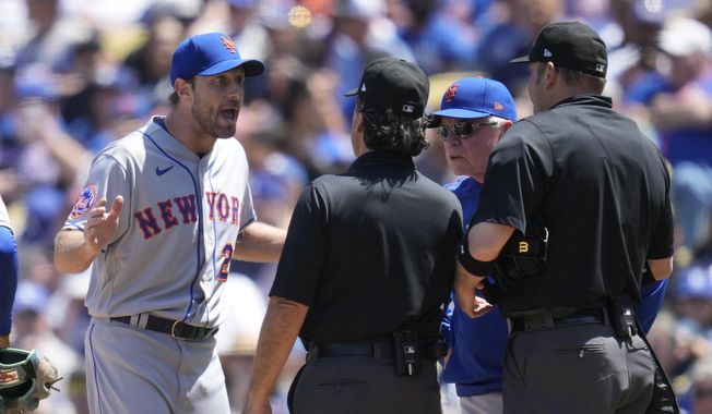 New York Mets starting pitcher Max Scherzer (21) and manager Buck Showalter dispute a call from umpire Phil Cuzzi, center, and umpire Dan Bellino, right, after they found a problem with Scherzer&#x27;s glove during the fourth inning of a baseball game in Los Angeles, Wednesday, April 19, 2023. Scherzer was ejected from the game. (AP Photo/Ashley Landis)