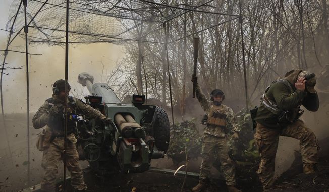 Ukrainian soldiers fire howitzer D-30 at the frontline near Bakhmut, Donetsk region, Ukraine, Wednesday, April 19, 2023. (Roman Chop via AP)