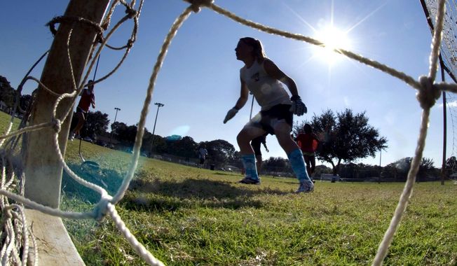 The goalkeeper guards the net as girls take part in the first day of tryouts for the Fort Walton Beach High School girls&#x27; soccer team in Fort Walton Beach, Fla., on Oct. 10, 2012.