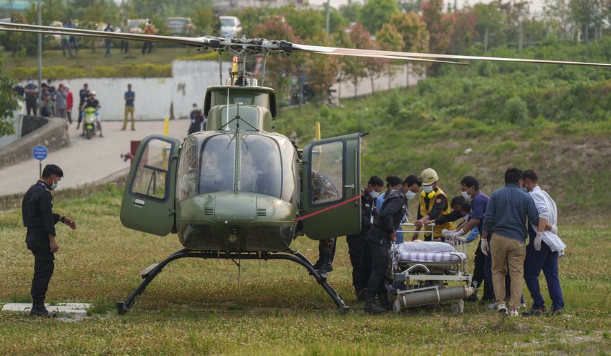 Hospital staff get ready to evacuate as a helicopter carrying injured Indian climber Anurag Maloo who was rescued from Annapurna region lands at Medicity hospital in Kathmandu, Nepal, Thursday, April 20, 2023. The Indian climber who fell into a 300-meter (980-foot) crevasse on Mount Annapurna on Monday was rescued Thursday. (AP Photo/Niranjan Shrestha)