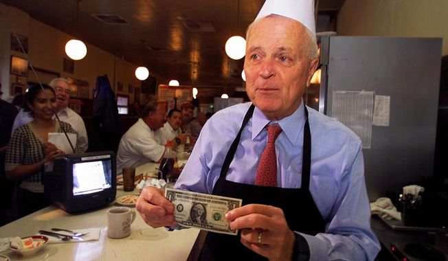 Los Angeles Mayor Richard Riordan picks up a tip from a customer at his restaurant &quot;The Pantry,&quot; Friday, June 29, 2001, in downtown Los Angeles. Riordan, the moderate Republican multimillionaire who won two terms as mayor in Democrat-friendly Los Angeles and ran unsuccessfully for governor, died Wednesday, April 19, 2023. He was 92. (AP Photo/Damian Dovarganes) **FILE**