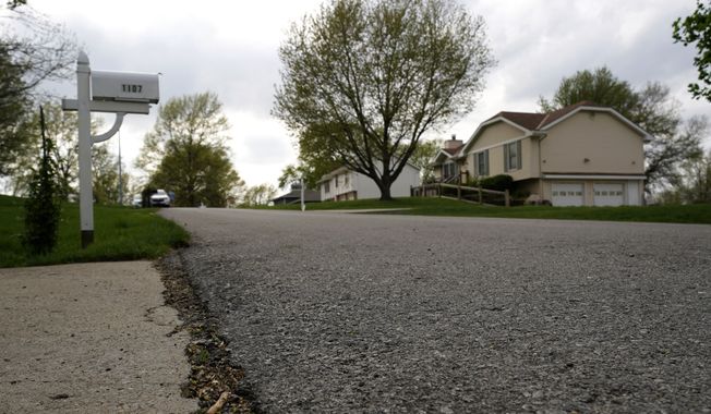 84-year-old Andrew Lester&#x27;s house, right, is seen up the street, Wednesday, April 19, 2023, from a neighbor&#x27;s driveway where 16-year-old Ralph Yarl received help after he was shot by Lester a week earlier in Kansas City, Mo. (AP Photo/Charlie Riedel)