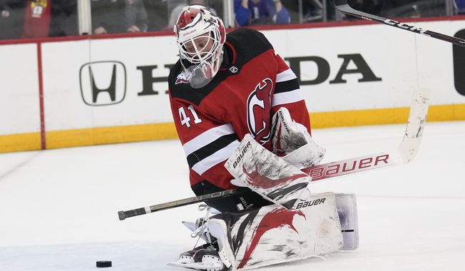 New Jersey Devils&#x27; Vitek Vanecek looks at the puck as it gets by him during the third period of Game 2 of the team&#x27;s NHL hockey Stanley Cup first-round playoff series against the New York Rangers in Newark, N.J., Thursday, April 20, 2023. The Rangers won 5-1. (AP Photo/Seth Wenig)