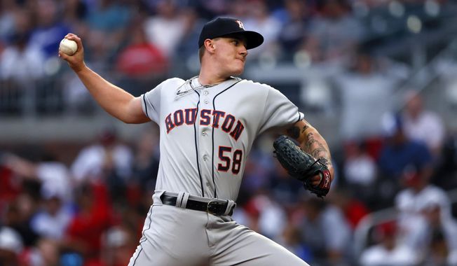 Houston Astros starting pitcher Hunter Brown throws during the first inning of the team&#x27;s baseball game against the Atlanta Braves, Friday, April 21, 2023, in Atlanta. (AP Photo/Butch Dill)