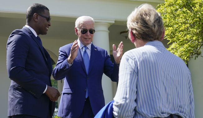 President Joe Biden speaks with Energy Secretary Jennifer Granholm, right, and Environmental Protection Agency administrator Michael Regan, left, after signing an executive order that would create the White House Office of Environmental Justice in the Rose Garden of the White House in Washington, Friday, April 21, 2023. (AP Photo/Susan Walsh)