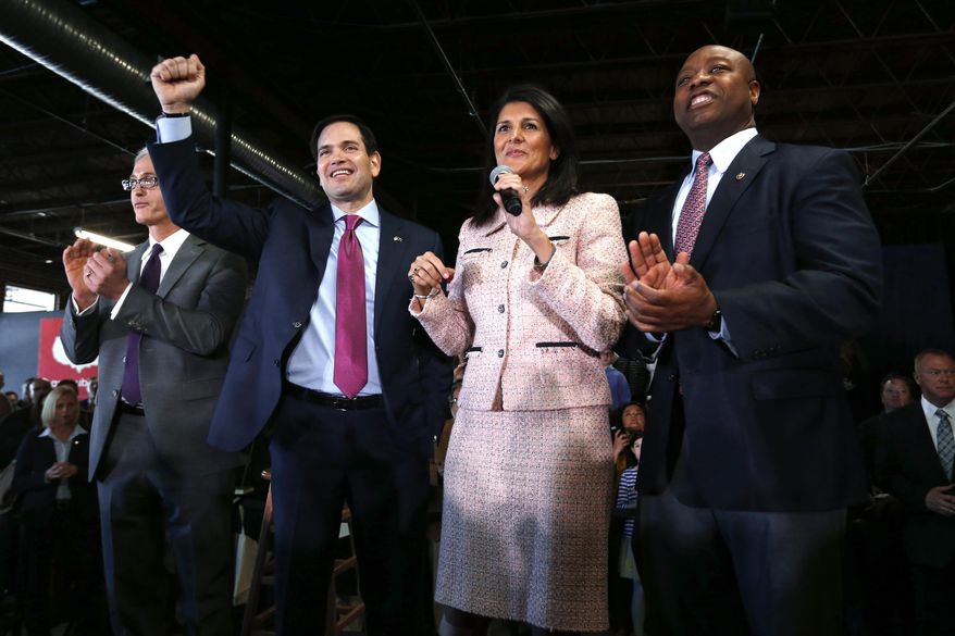 FILE - Republican presidential candidate Sen. Marco Rubio, R-Fla., raises his arm with South Carolina Gov. Nikki Haley and Sen. Tim Scott, R-S.C., during a town hall, Feb. 18, 2016 in Greenville, S.C. (AP Photo/Paul Sancya, File)