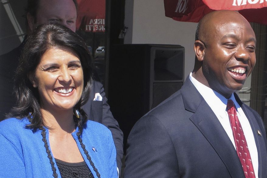 FILE - South Carolina Republican gubernatorial candidate state Rep. Nikki Haley and Republican congressional candidate Tim Scott campaign Oct. 7, 2010, in North Charleston, S.C. As the 2024 Republican field begins to take shape, the potential of a faceoff between Haley and Scott is putting some of their mutual supporters in the critical early-voting state of South Carolina in a conundrum as they weigh which candidate to support. (AP Photo/Bruce Smith, File)
