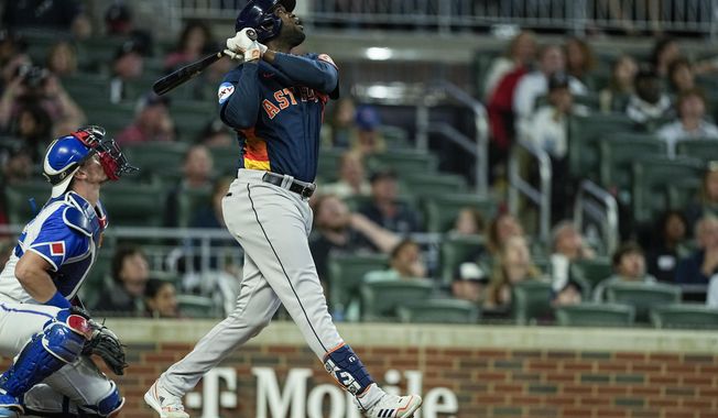 Houston Astros&#x27; Yordan Alvarez (44) watches after hitting a two-run home run in the sixth inning of a baseball game against the Atlanta Braves, Saturday, April 22, 2023, in Atlanta. (AP Photo/Brynn Anderson)