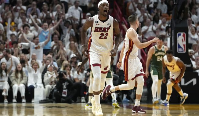 Miami Heat forward Jimmy Butler (22) reacts after shooting a 3-pointer during the first half of Game 3 in a first-round NBA basketball playoff series against the Milwaukee Bucks, Saturday, April 22, 2023, in Miami. (AP Photo/Lynne Sladky)