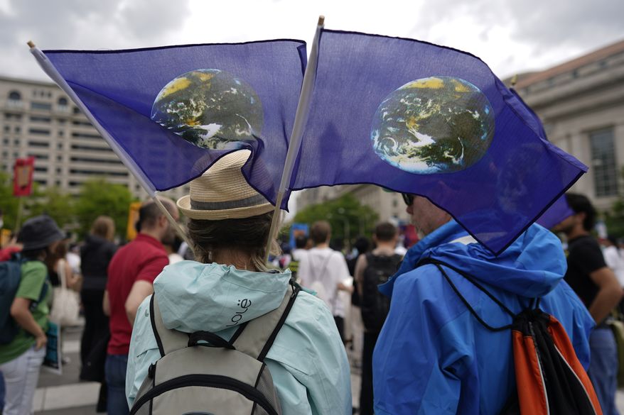 Climate activists hold a rally to protest the use of fossil fuels on Earth Day at Freedom Plaza, Saturday, April 22, 2023, in Washington. (AP Photo/Carolyn Kaster)