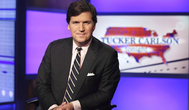 Tucker Carlson, host of &quot;Tucker Carlson Tonight,&quot; poses for photos in a Fox News Channel studio on March 2, 2017, in New York. (AP Photo/Richard Drew, File)