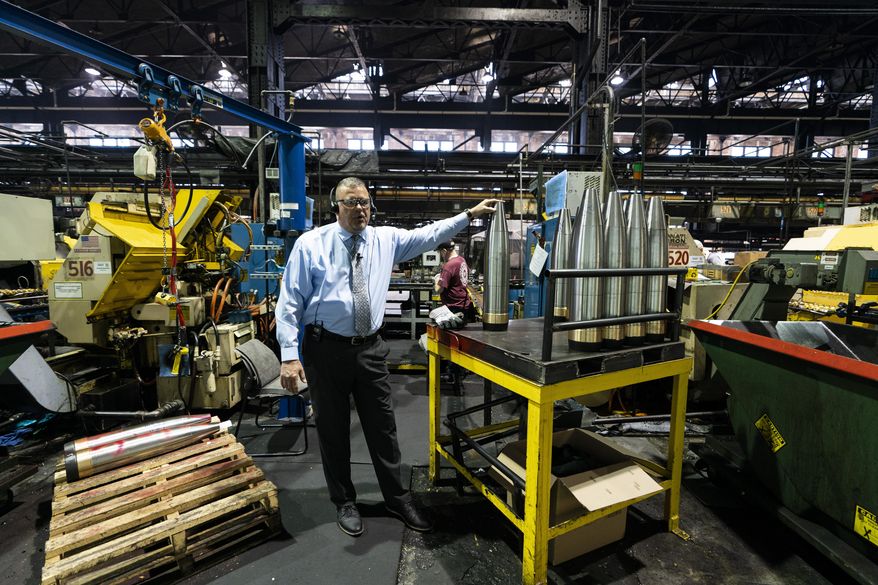 Richard Hansen, a Navy veteran who is the Army commander's representative at the Scranton Army Ammunition Plant with members of the media during a tour of the manufacturing process of 155 mm M795 artillery projectiles in Scranton, Pa., Thursday, April 13, 2023. One of the most important munitions of the Ukraine war comes from a historic factory in this city built by coal barons, where tons of steel rods are brought in by train to be forged into the artillery shells Kyiv can’t get enough of — and that the U.S. can’t produce fast enough. (AP Photo/Matt Rourke)