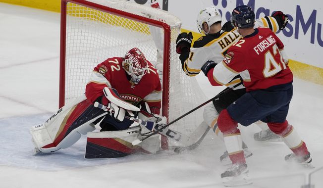 Florida Panthers goaltender Sergei Bobrovsky (72)and defenseman Gustav Forsling (42) defend the net from a shot by Boston Bruins left wing Taylor Hall (71) during the first period of Game 4 of an NHL hockey Stanley Cup first-round playoff series, Sunday, April 23, 2023, in Sunrise, Fla. (AP Photo/Marta Lavandier)