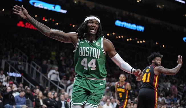 Boston Celtics center Robert Williams III (44) reacts after diving for the ball against Atlanta Hawks forward Saddiq Bey (41) during the first half of Game 4 of a first-round NBA basketball playoff series, Sunday, April 23, 2023, in Atlanta. (AP Photo/Brynn Anderson)