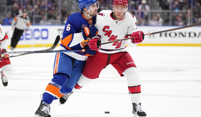 New York Islanders&#x27; Ryan Pulock (6) checks Carolina Hurricanes&#x27; Paul Stastny during the first period of Game 4 of an NHL hockey Stanley Cup first-round playoff series, Sunday, April 23, 2023, in Elmont, N.Y. (AP Photo/Frank Franklin II)