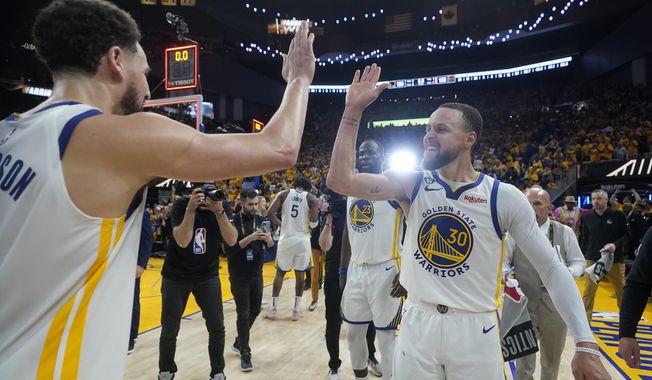 Golden State Warriors guard Klay Thompson, left, celebrates with guard Stephen Curry (30) after the Warriors defeated the Sacramento Kings in Game 4 in the first round of the NBA basketball playoffs in San Francisco, Sunday, April 23, 2023. (AP Photo/Jeff Chiu)