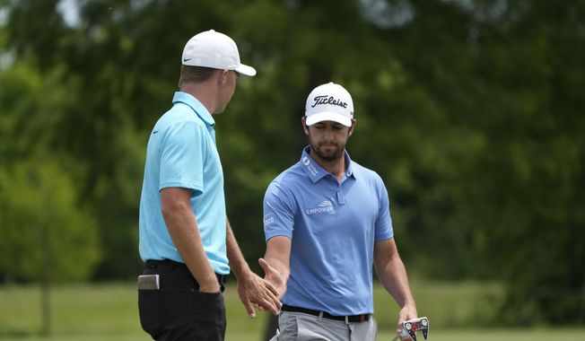 Davis Riley, right, greets his teammate Nick Hardy on the seventh green during the final round of the PGA Zurich Classic golf tournament at TPC Louisiana in Avondale, La., Sunday, April 23, 2023. (AP Photo/Gerald Herbert)