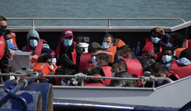 People thought to be migrants who undertook the crossing from France in small boats and were picked up in the Channel, wait to be disembarked from a British border force vessel, in Dover, southeast England, on June 17, 2022. Several asylum-seekers and refugee groups began a court challenge on Monday, April 24, 2023, to the British government’s plan to send hundreds of migrants on a one-way trip to Rwanda. (AP Photo/Matt Dunham, File)