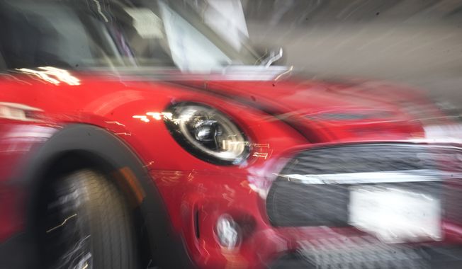 A 2023 Cooper Clubman S sports-utility vehicle is displayed on the showroom floor of a Mini dealer on Thursday, April 20, 2023, in Highlands Ranch, Colo. On Tuesday, the Conference Board reports on U.S. consumer confidence for April. (AP Photo/David Zalubowski)