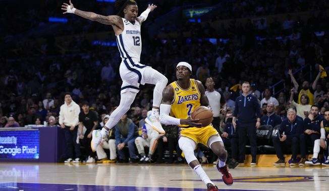 Los Angeles Lakers&#x27; Jarred Vanderbilt (2) drives to the basket under defense by Memphis Grizzlies&#x27; Ja Morant (12) during the first half in Game 4 of a first-round NBA basketball playoff series Monday, April 24, 2023, in Los Angeles. (AP Photo/Jae C. Hong)