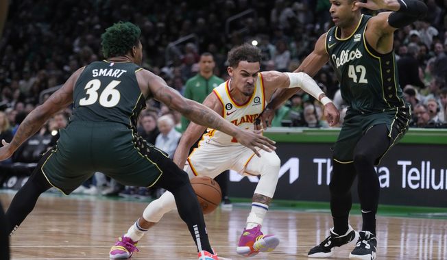 Atlanta Hawks guard Trae Young, center, drives to the basket against Boston Celtics guard Marcus Smart (36) and center Al Horford (42) during the first half of Game 5 in a first-round NBA basketball playoff series Tuesday, April 25, 2023, in Boston. (AP Photo/Charles Krupa)