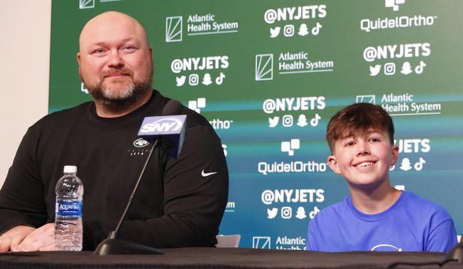 New York Jets general manager Joe Douglas and Make-A-Wish recipient Kyle Stickles, answer questions from reporters during an NFL football pre-draft press conference on Tuesday, April 25, 2023, in Florham Park, N.J. (AP Photo/Noah K. Murray)