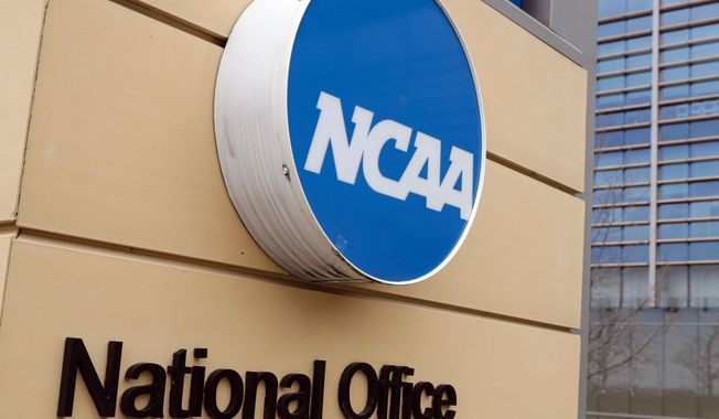 Signage at the headquarters of the NCAA is viewed in Indianapolis, March 12, 2020. Lawmakers in Arkansas, Texas and elsewhere are working to remove barriers between college athletes trying to cash in on their fame and the schools for which they play. The latest legislative maneuvering paves the way for schools and their fundraising arms to be directly involved in securing and paying for their athletes’ name, image and likeness deals. These amended laws are also trying to shield athletic departments from NCAA enforcement. (AP Photo/Michael Conroy) **FILE**