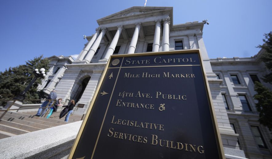 Visitors stand on the west steps of the Colorado state Capitol, Sunday, April 23, 2023, in Denver. Colorado is set to become the first state to sign a "right to repair" law allowing farmers to fix their own equipment with a bill signing Tuesday afternoon, April 25, by Democratic Gov. Jared Polis of Colorado. The law will force manufacturers to provide the necessary manuals, tools, parts and software to farmers, so they can fix their own machines. (AP Photo/David Zalubowski, File)