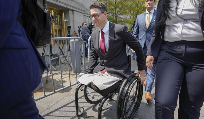 Brian Kolfage leaves court after being sentenced for defrauding donors to the &quot;We Build the Wall&quot; effort, Wednesday, April 26, 2023, in New York. The co-founder of a fundraising group linked to Steve Bannon that promised to help Donald Trump construct a wall along the southern U.S. border has been sentenced to four years and three months in prison. (AP Photo/John Minchillo)