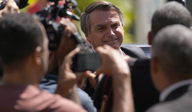 Former Brazilian President Jair Bolsonaro leaves Federal Police headquarters after giving testimony over the Jan. 8 attacks in Brasilia, Brazil, Wednesday, April 26, 2023. Thousands of Bolsonaro supporters trashed the presidential palace, the Supreme Court and Congress one week into President Luiz Inácio Lula da Silva&#x27;s third term in office. (AP Photo/Gustavo Morteno)