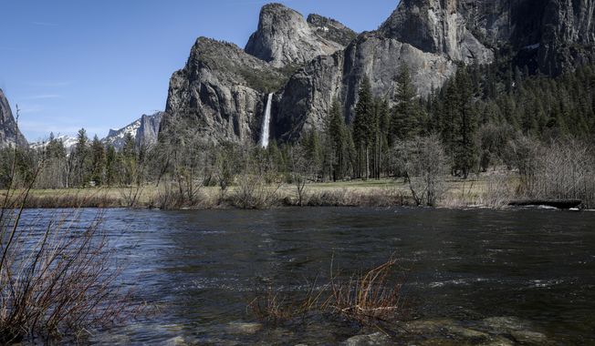 High water levels can be seen on the Merced River in Yosemite National Park, Calif., on Tuesday, April 25, 2023. Much of the famed valley at California&#x27;s Yosemite National Park will be temporarily closed starting Friday, April 28, due to a forecast of flooding as rising temperatures melt the Sierra Nevada&#x27;s massive snowpack.  (Brontë Wittpenn/San Francisco Chronicle via AP)