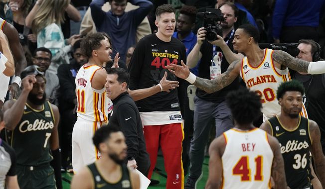 Atlanta Hawks guard Trae Young (11) is congratulated after the team&#x27;s win over the Boston Celtics in Game 5 in a first-round NBA basketball playoff series Tuesday, April 25, 2023, in Boston. (AP Photo/Charles Krupa)