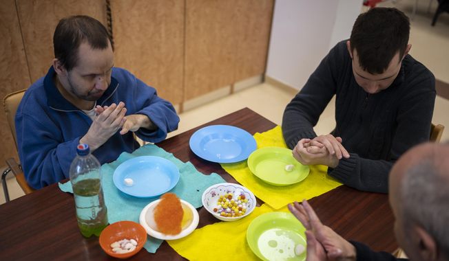 Residents of Blessed László Battyhány-Strattman Institute work felt during their morning routine, in Budapest, Monday, April 17, 2023. Francis will meet with children with disabilities, refugees and those living in poverty on the three-day trip in Hungary that begins Friday. (AP Photo/Denes Erdos)