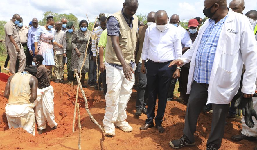 Kenya Interior minister Kithure Kindiki, centre, in white shirt, inspects graves where victims of a Christian Cult are buried at a forest in Shakahola, outskirts of tourist town of Malindi, Coastal Kenya Tuesday, April 25, 2023. Kenya's president William Ruto said Monday that the starvation deaths of dozens of followers of pastor Paul Makenzi, who was arrested on suspicion of telling his followers to fast to death in order to meet Jesus, is akin to terrorism (AP Photo)