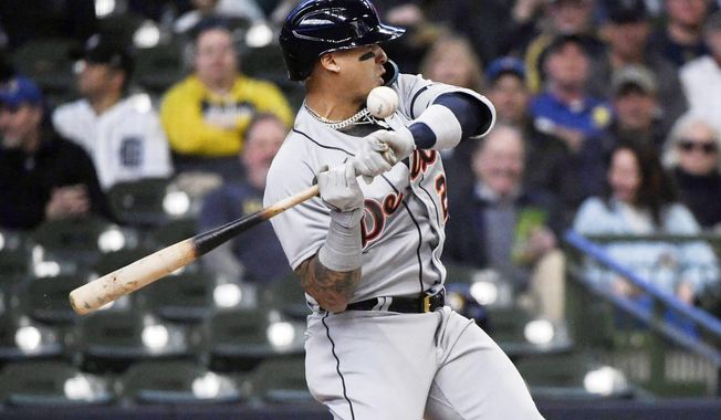 Detroit Tigers&#x27; Javier Baez gets hit by the pitch from Milwaukee Brewers&#x27; Freddy Peralta during the first inning of a baseball game, Wednesday, April 26, 2023, in Milwaukee. (AP Photo/Kenny Yoo)