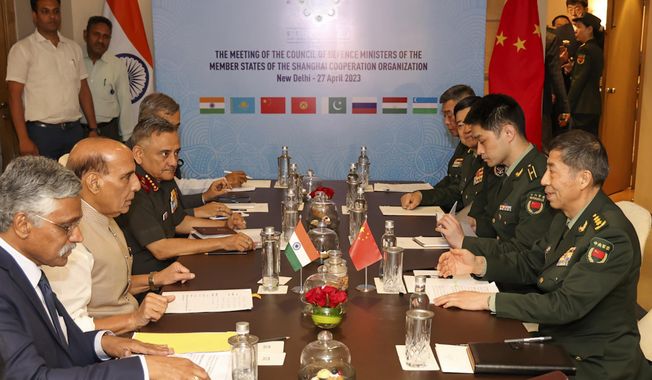 In this photo provided by the Indian Defence Ministry, Indian Defence Minister Rajnath Singh, seated third left, attends a meeting with his Chinese counterpart Li Shangfu, right, during the Shanghai Cooperation Organization Defence Minister&#x27;s Meeting in New Delhi, India, Thursday, April 27, 2023. (Indian Defence Ministry via AP)
