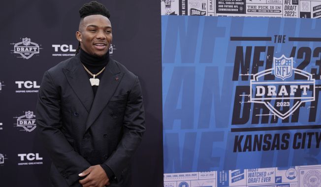 Texas running back Bijan Robinson arrives on the red carpet before the first round of the NFL football draft, Thursday, April 27, 2023, in Kansas City, Mo. (AP Photo/Charlie Riedel)