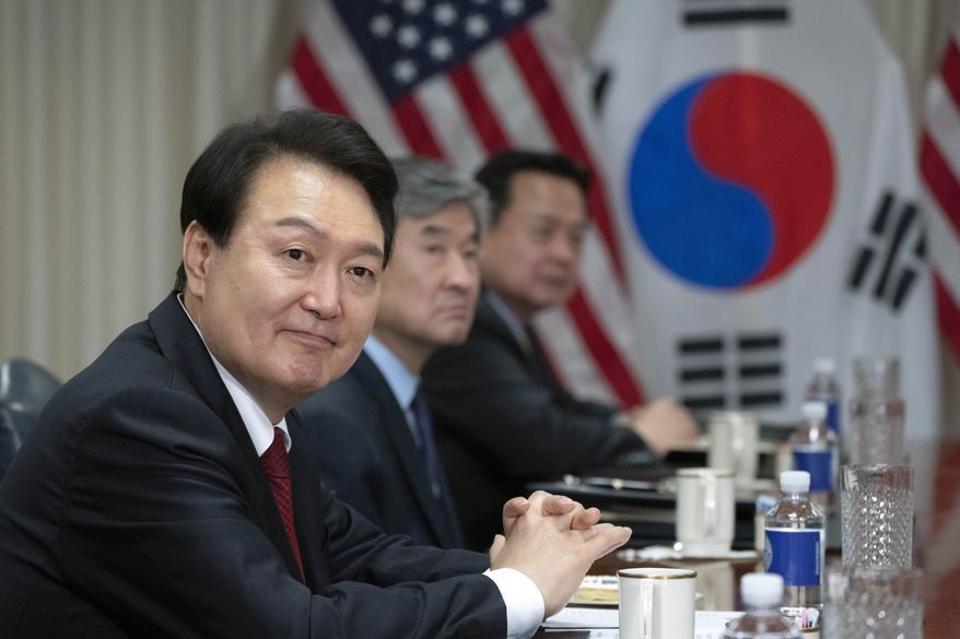 South Korea's President Yoon Suk Yeol glances toward members of the media during a meeting with Secretary of Defense Lloyd Austin at the Pentagon in Washington, Thursday, April 27, 2023. (AP Photo/Manuel Balce Ceneta)