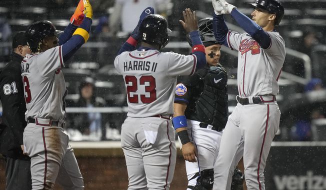 Atlanta Braves&#x27; Matt Olson, right, celebrates with Michael Harris II, middle and Ronald Acuna Jr. after hitting a three-run home run during the fifth inning of the team&#x27;s baseball game against the New York Mets, Friday, April 28, 2023, in New York. (AP Photo/Bryan Woolston)